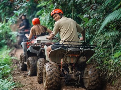 handsome asian man looking back and smiling while riding atv handsome asian man looking back and smiling while riding atv at atv arena with his partner